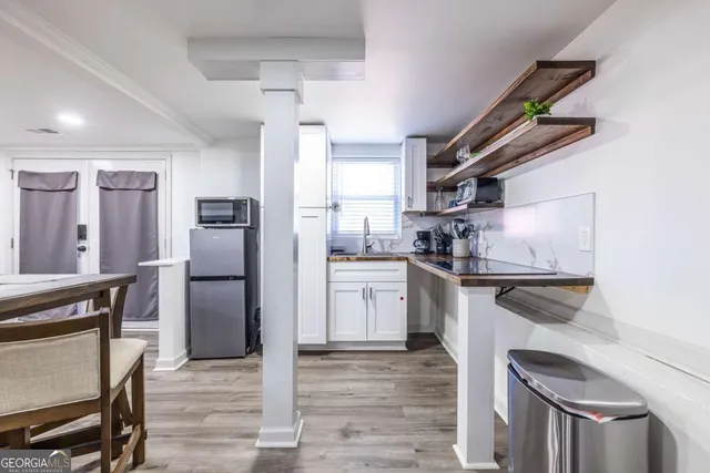 a kitchen with a refrigerator and a sink