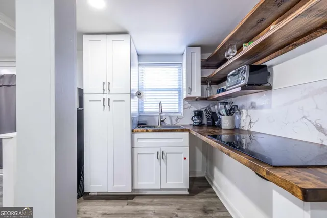 a kitchen with stainless steel appliances granite countertop a sink a stove and a refrigerator