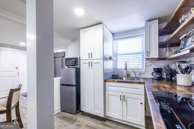 a kitchen with a refrigerator and a stove top oven
