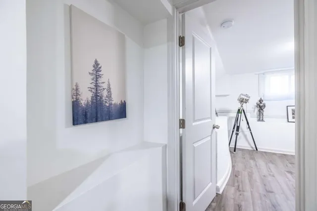 a view of empty room with wooden floor