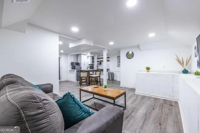 a living room with furniture and wooden floor