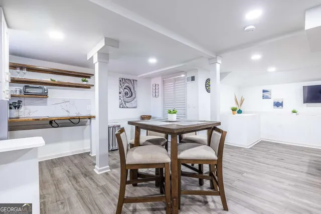 a view of a dining room with furniture and wooden floor