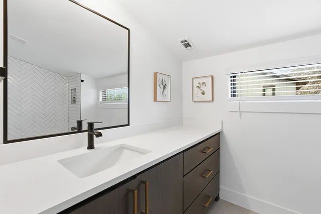 a bathroom with a sink and a mirror