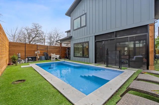 a view of a house with swimming pool and sitting area