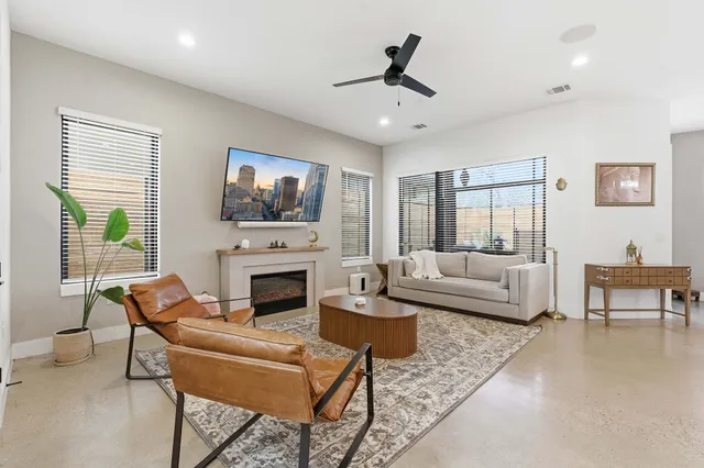 a living room with furniture a fireplace and a flat screen tv