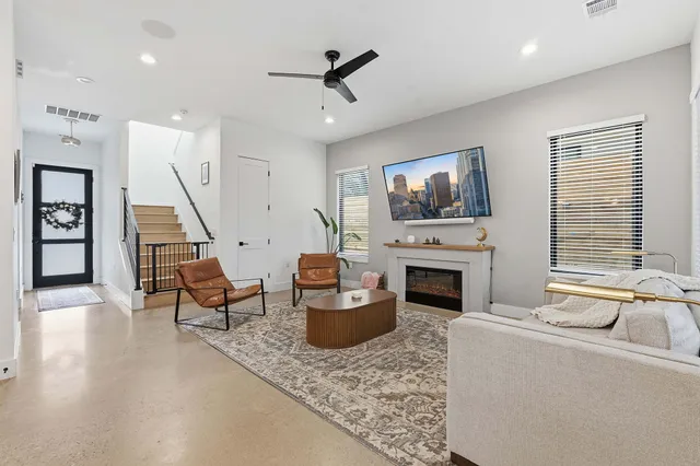 a living room with furniture a fireplace and a flat screen tv