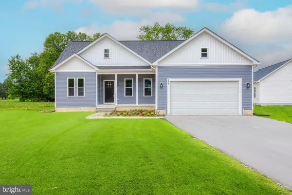 a view of house with a yard