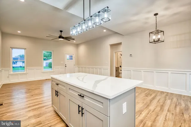 a view of a kitchen center island and stainless steel appliances