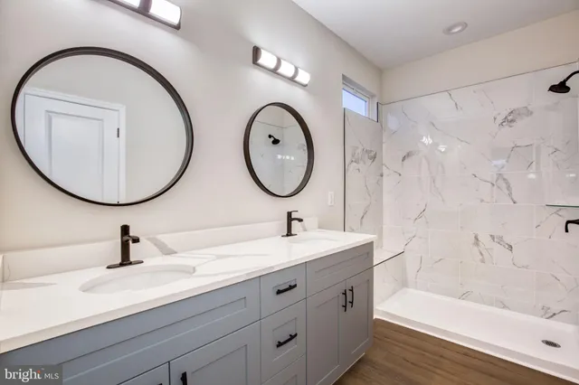 a bathroom with a double vanity sink and a mirror