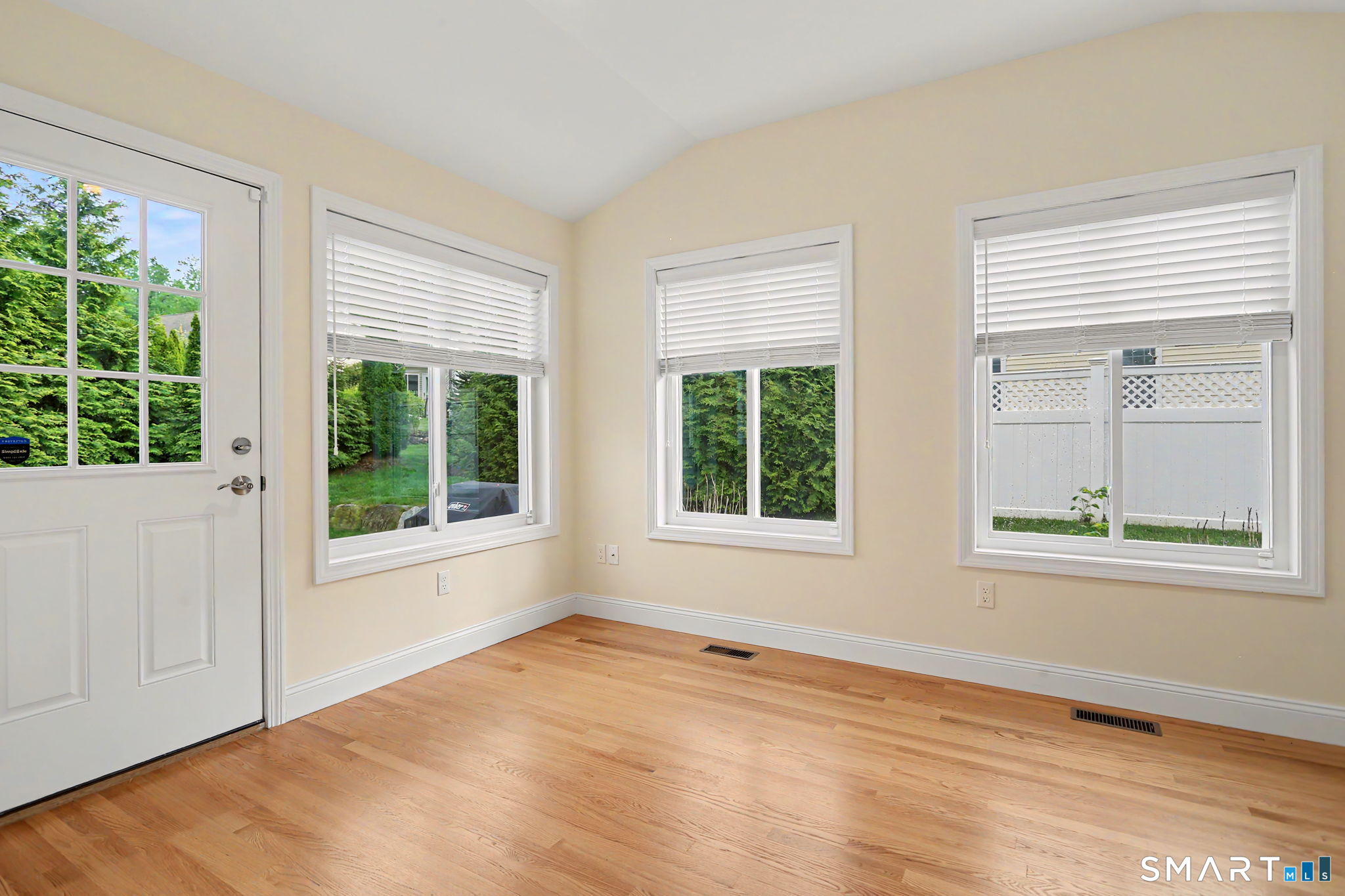 223 Meadow Brook Road, Unit 223 Oxford, CT 06478 - Photo 13 of 34 an empty room with wooden floor and windows