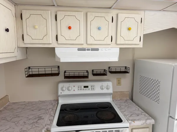 a stove top oven sitting inside of a kitchen