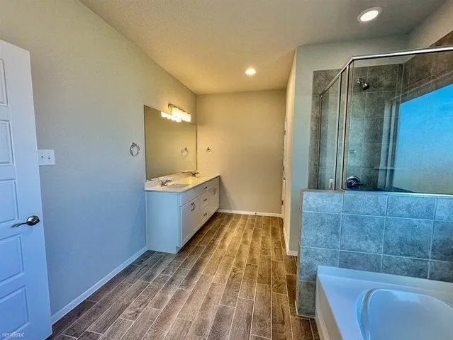 a bathroom with a bathtub and a shower