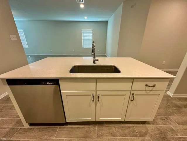 an empty room with a empty space and windows