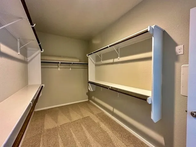 a view of kitchen with refrigerator and microwave