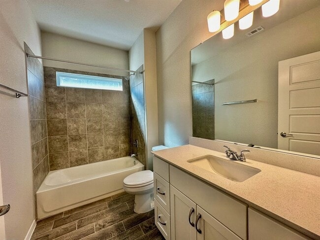 140 Keltic Drive Kyle, TX 78640 - Photo 7 of 20 a bathroom with a sink a toilet and bathtub