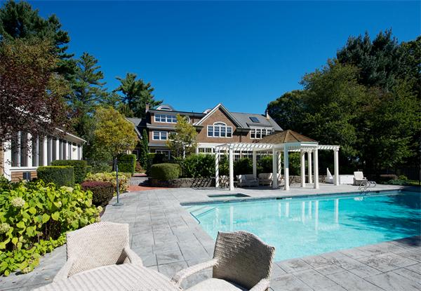 555 Concord Road Sudbury, MA 01776 - Photo 20 of 29 a front view of a house with a yard table and chairs
