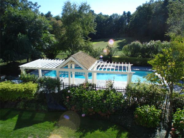 555 Concord Road Sudbury, MA 01776 - Photo 5 of 29 a front view of a house with a yard and fountain