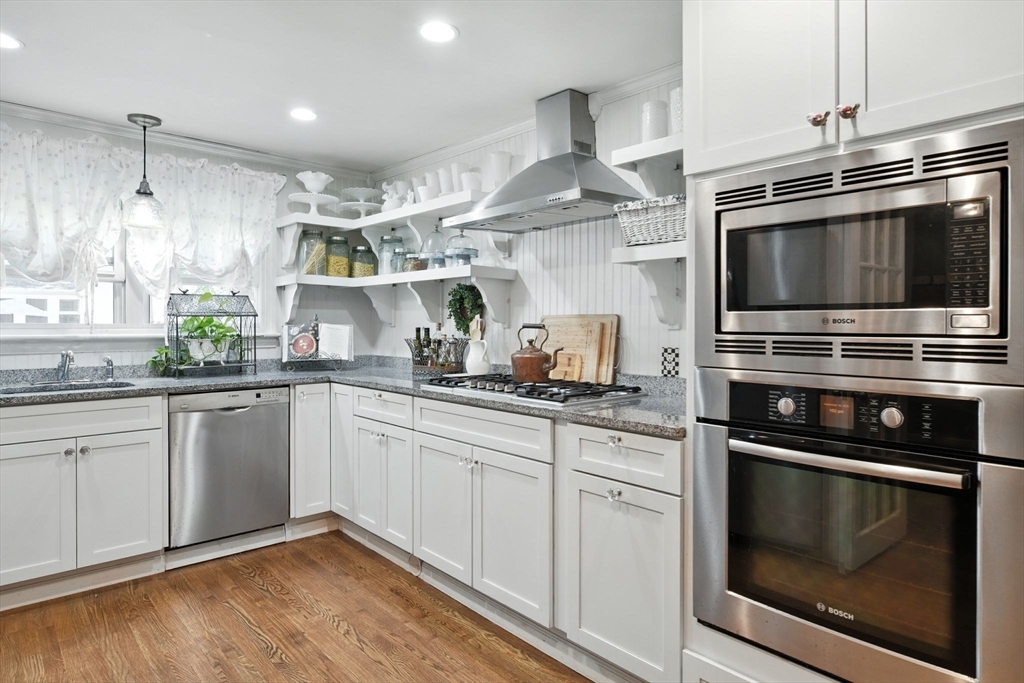 35 Plymouth Road Longmeadow, MA 01106 - Photo 14 of 41 a kitchen with stainless steel appliances a stove a microwave and white cabinets