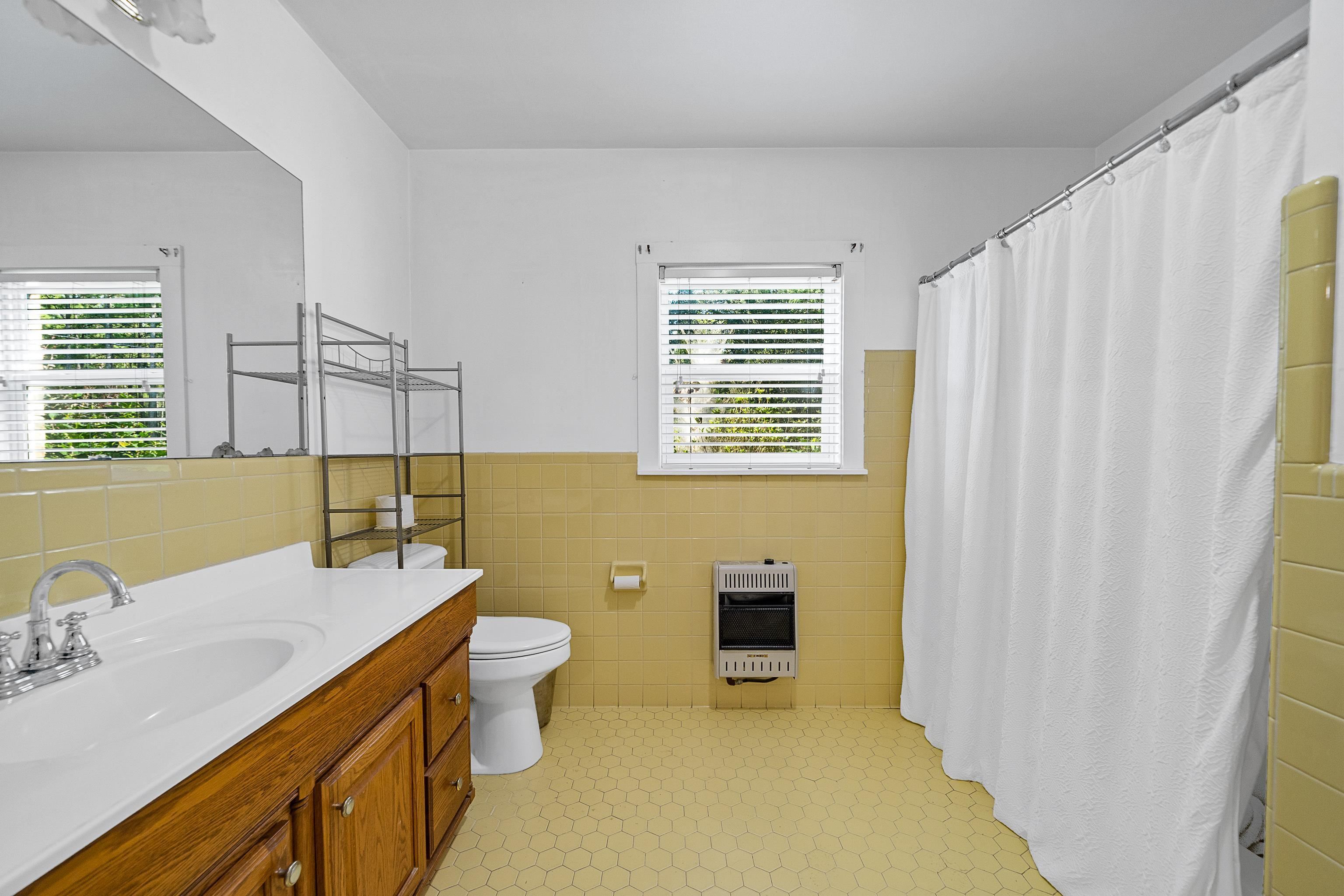 9350 Tompkins Road Stockton, AL 36579 - Photo 23 of 36 Bathroom featuring vanity, tile walls, wainscoting, a shower stall, and heating unit