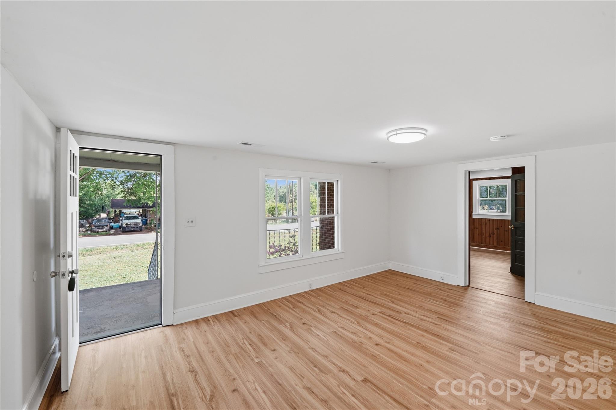 2231 Claremont Road Newton, NC 28658 - Photo 30 of 39 an empty room with wooden floor and windows