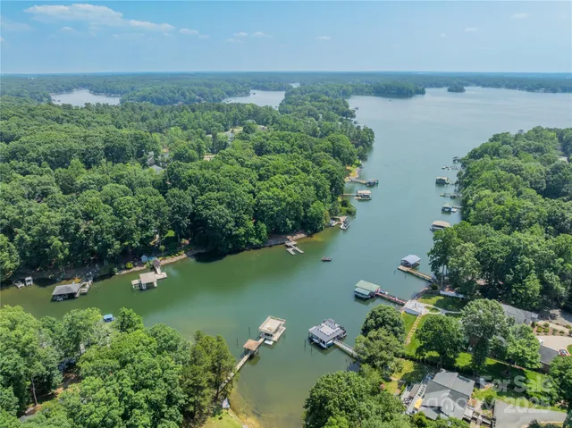 an aerial view of lake residential house with outdoor space and trees around