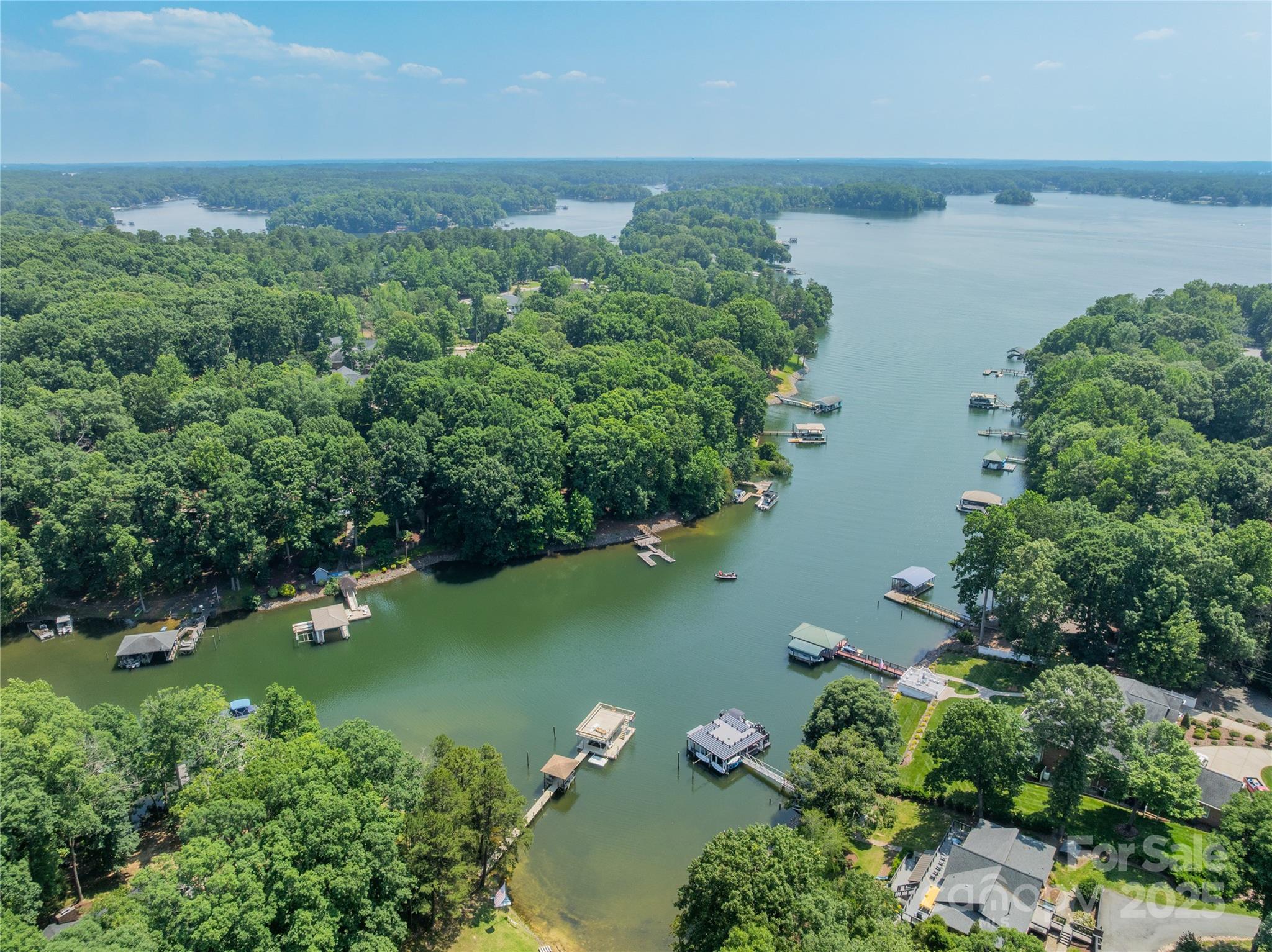 an aerial view of lake residential house with outdoor space and trees around