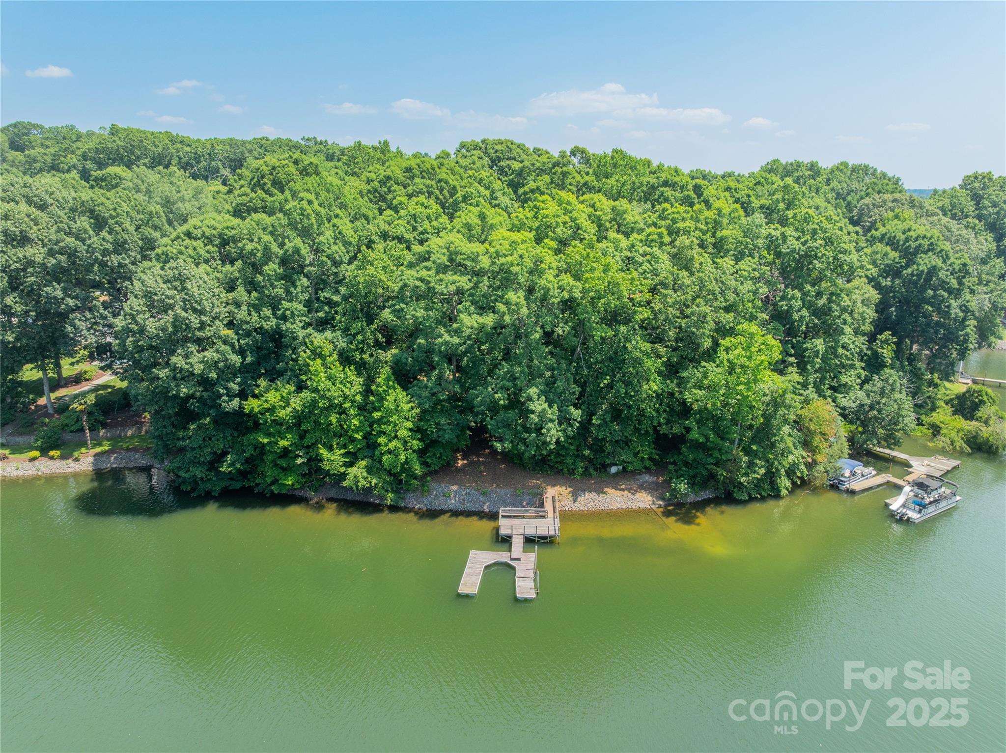 200 Greenbay Road Mooresville, NC 28117 - Photo 8 of 11 a swimming pool with lawn chairs and large trees