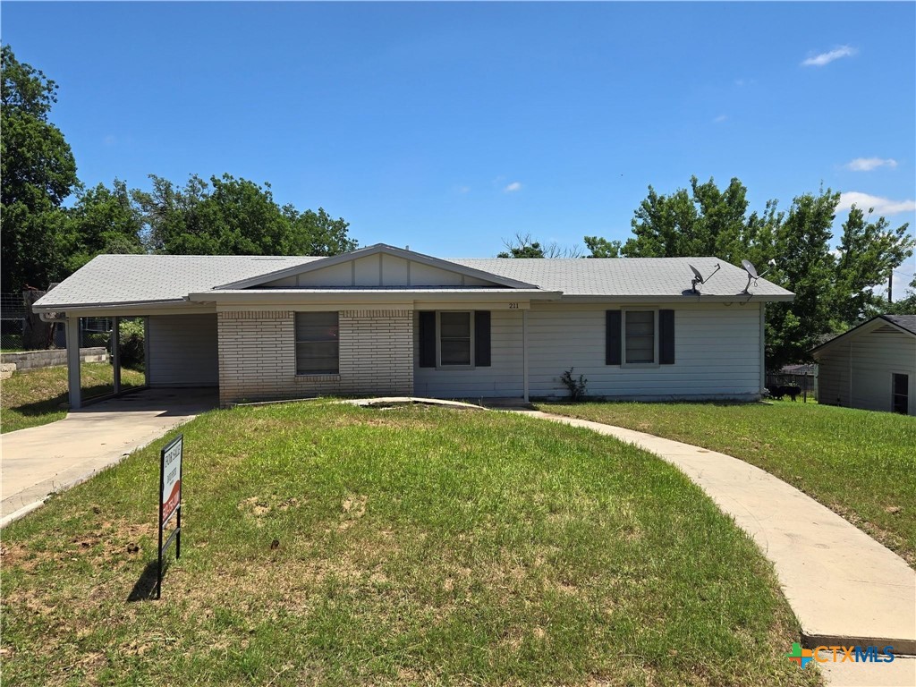 211 South Rice Street Lampasas, TX 76550 - Photo 1 of 1 a front view of a house with a garden