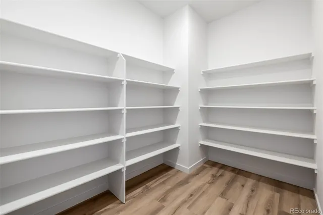 a view of walk in closet with empty racks