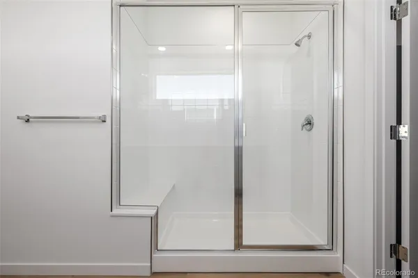 a bathroom with a glass shower door