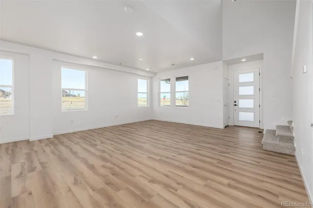 an empty room with windows and closet