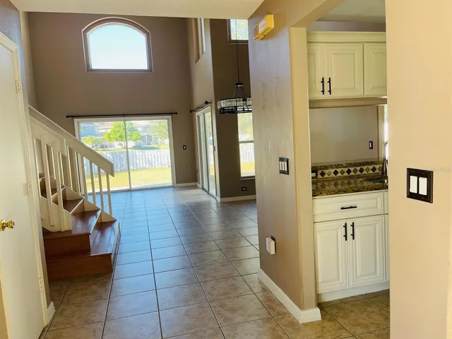 a view of a hallway with wooden floor and windows