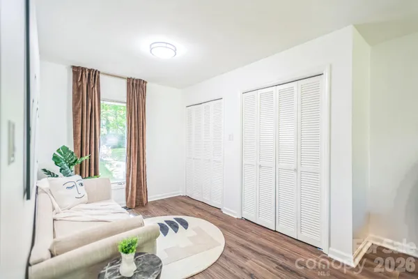 a living room with furniture and a bed