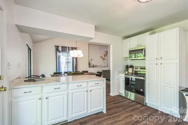 a kitchen with a stove a sink and a refrigerator