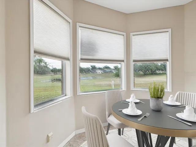 a view of a dining room with furniture window and outside view
