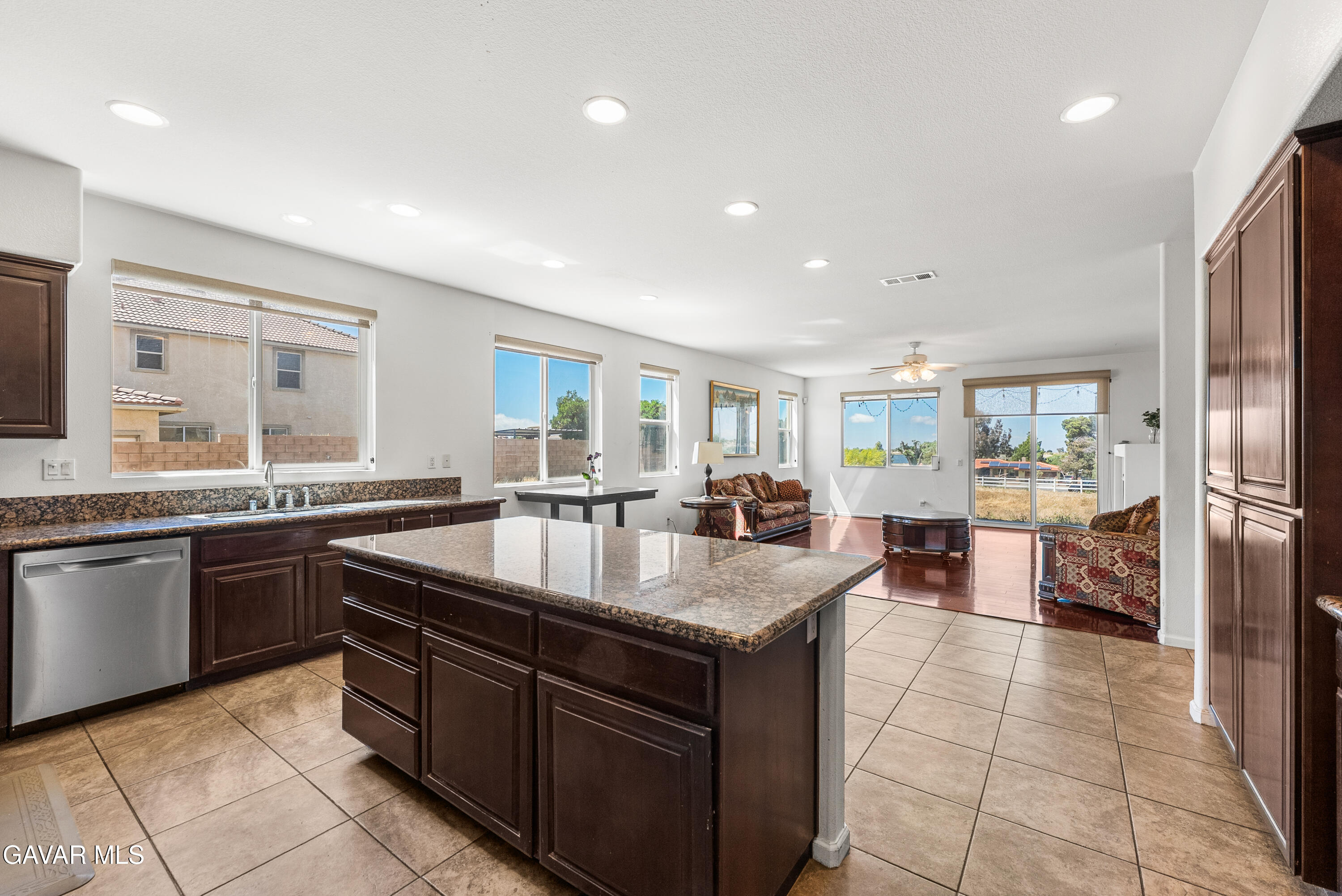658 Lago Lindo Road Palmdale, CA 93550 - Photo 34 of 91 a large kitchen with granite countertop a large counter top and stainless steel appliances