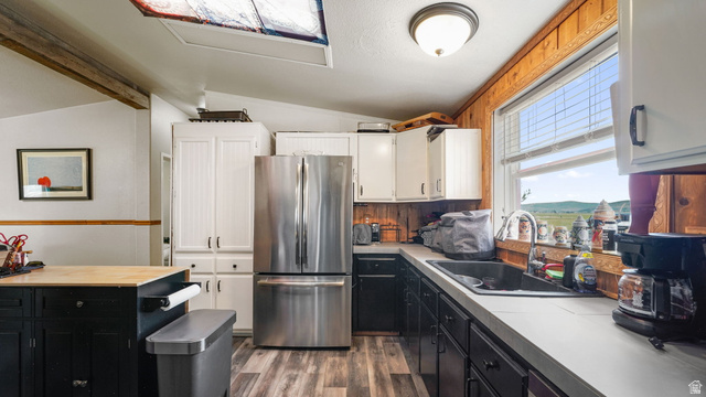 490 South Main Street Kamas, UT 84036 - Photo 15 of 25 Kitchen featuring stainless steel refrigerator, white upper cabinetry, dark lower cabinetry, light countertops, and wood-finish flooring