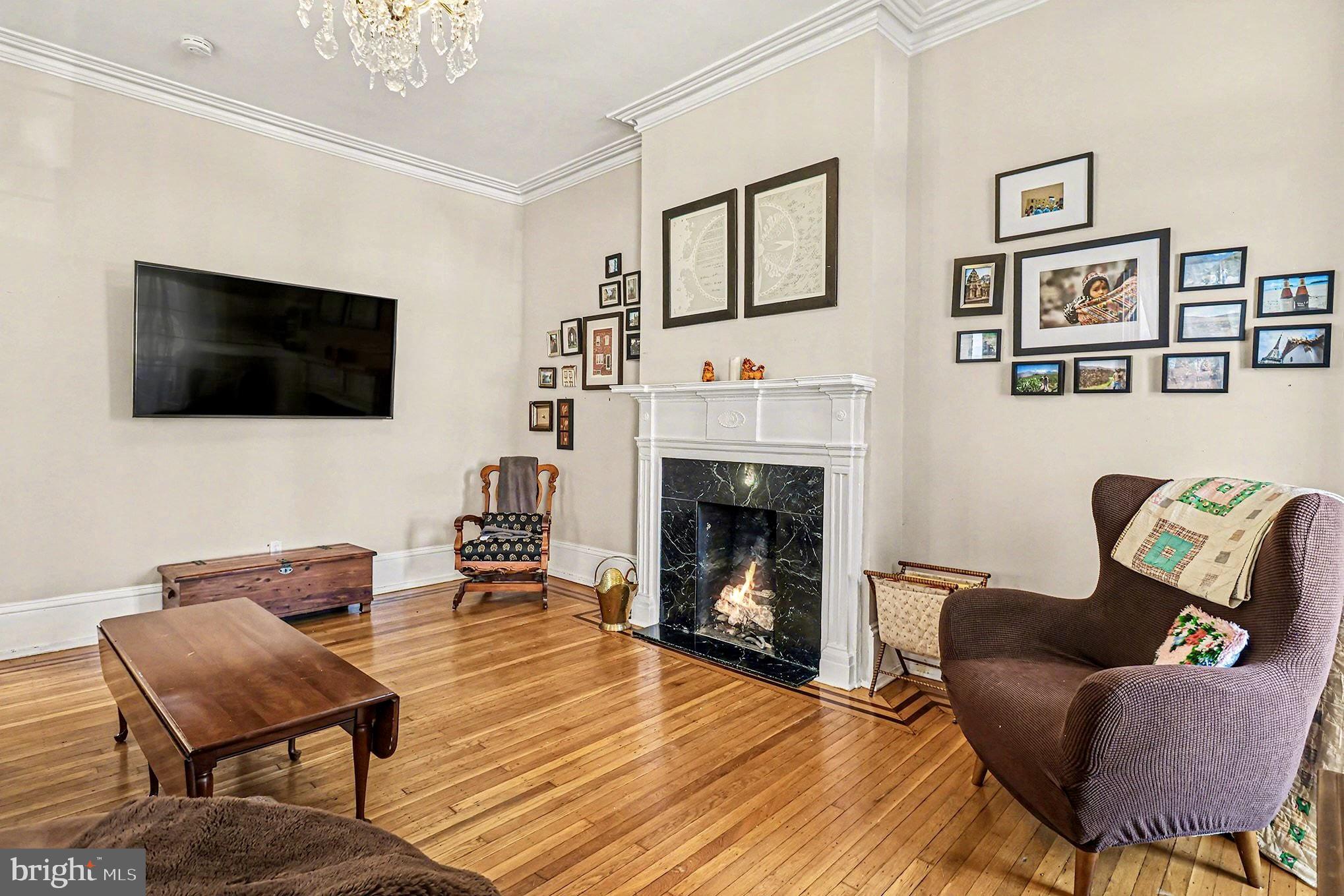 1410 Castle Avenue Philadelphia, PA 19145 - Photo 13 of 38 a living room with furniture a flat screen tv and a fireplace