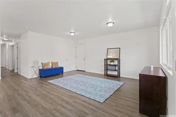 a living room with couch cabinet and a rug