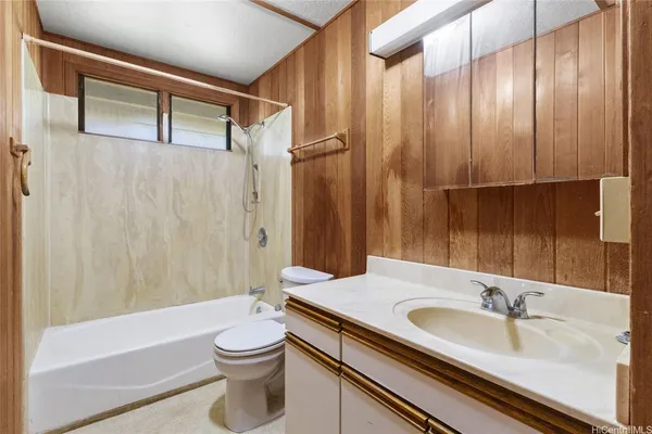 a bathroom with a sink a toilet and shower curtain