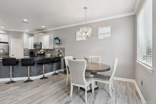 a view of a dining room with furniture and wooden floor