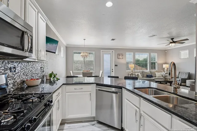 a kitchen with a sink stove and microwave
