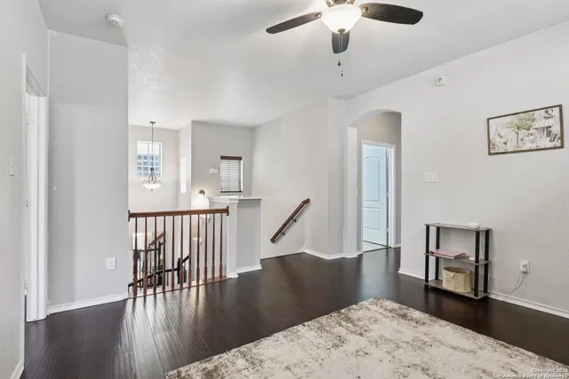 a view of a hallway with wooden floor and stairs