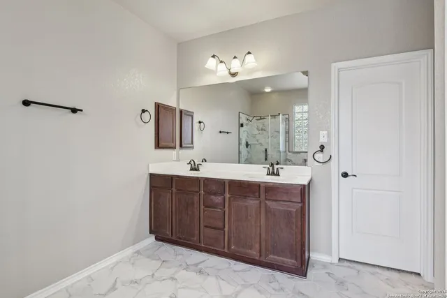 a spacious bathroom with a double vanity sink mirror and