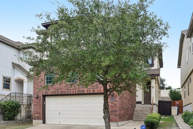 a tree in front of a white house