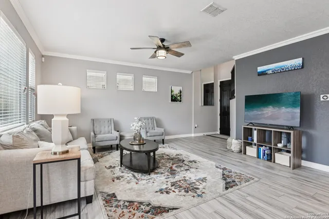 a living room with furniture and a wooden floor