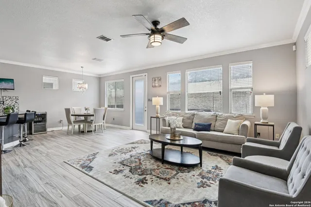 a living room with furniture and wooden floor