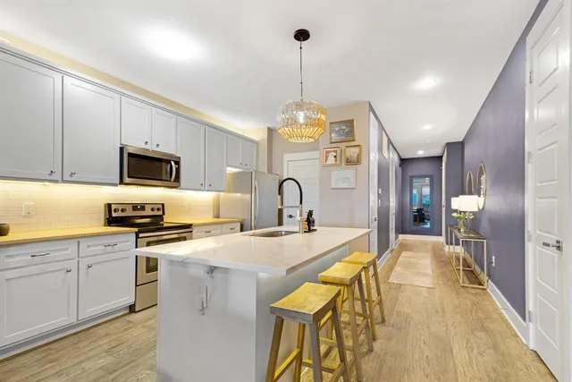 an aerial view of residential houses with outdoor space and lake view