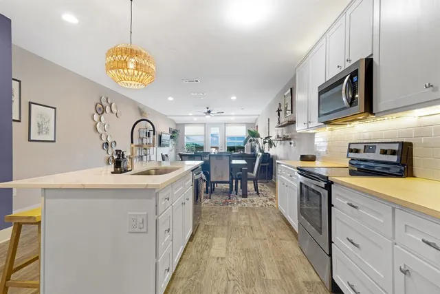 a kitchen with a sink appliances and cabinets