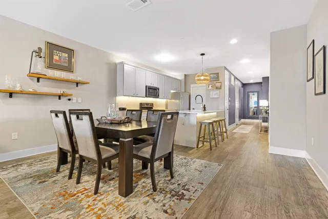 a kitchen with stainless steel appliances a sink a stove top oven a counter space and cabinets